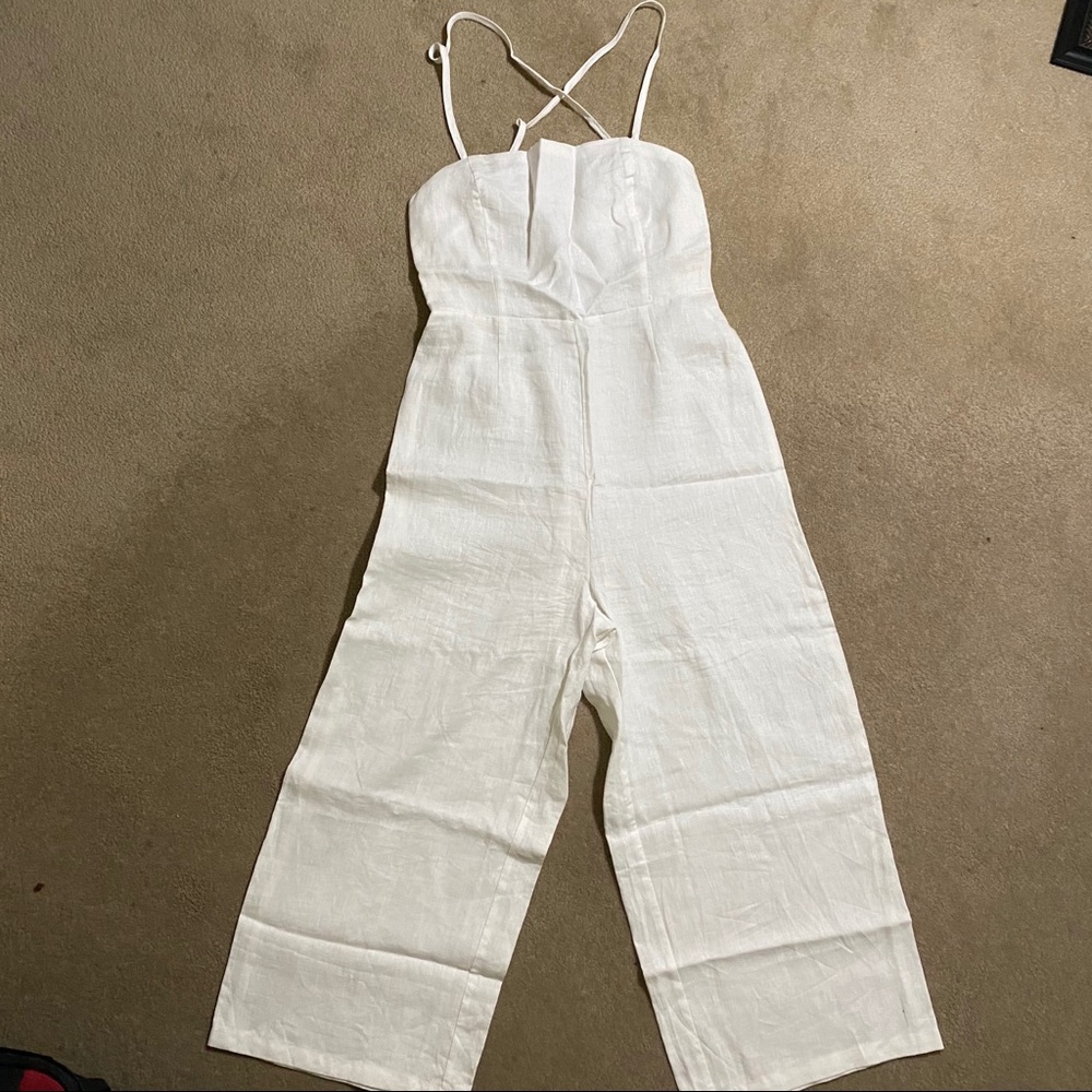 New white linen lace up back jumpsuit with pockets